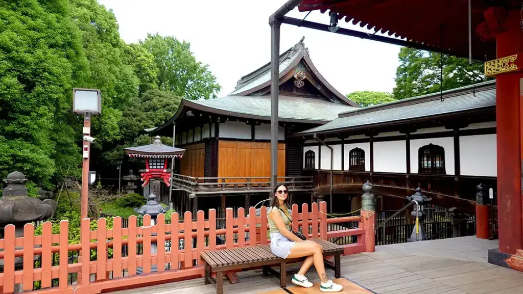 Noelia sentada en un banco de madera en el balcón del Templo Kiyomizu Kannon do en el Parque de Ueno de Tokio.
