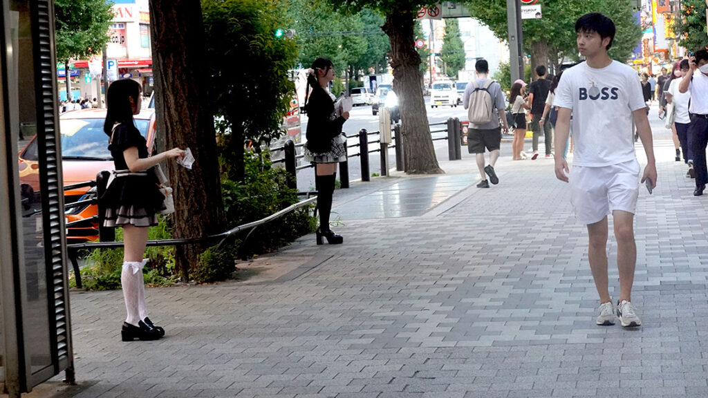 Chicas disfrazadas de sirvientas repartiendo publicidad de un Maid Café en la calle de Akihabara.
