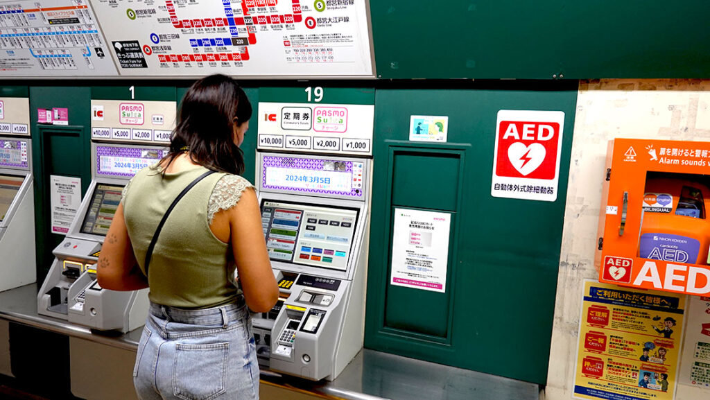 Noelia comprando un billete individual de metro en una máquina automática para ir a Asakusa.