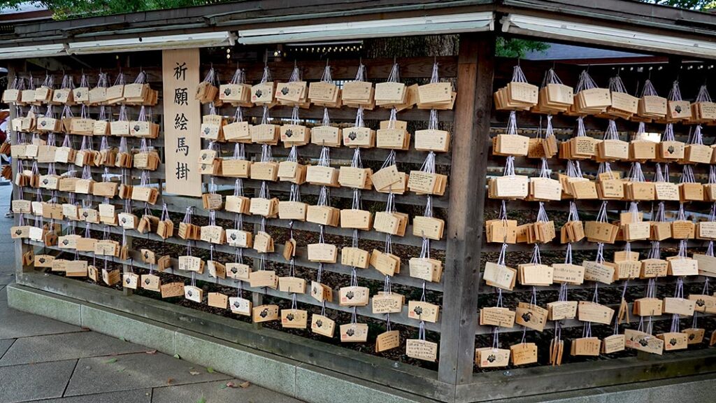 Centenas de tablillas de madera Ema con deseos escritos colgando alrededor de un árbol sagrado en Tokio.