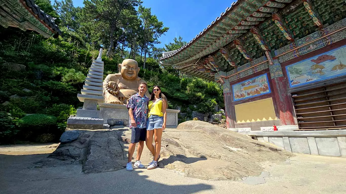 Joan y Noelia junto a una pagoda y el Gran Buda dorado del Templo Haedong Yonggungsa.