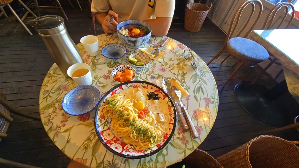 Dos viajeros Viajando en un restaurante con cestos de mimbre para dejar las mochilas