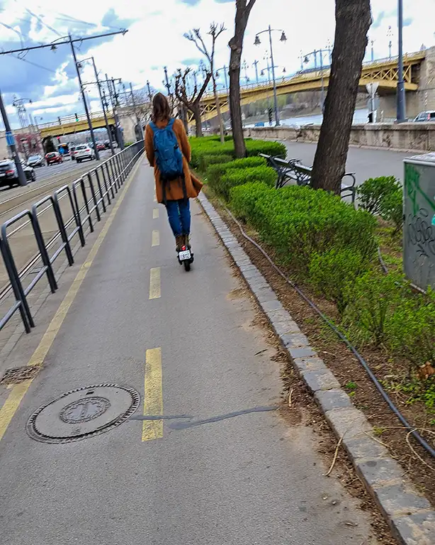 Noelia en carril bici con patinete por Budapest.